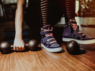 Athletic shoes on a dark wooden floor.