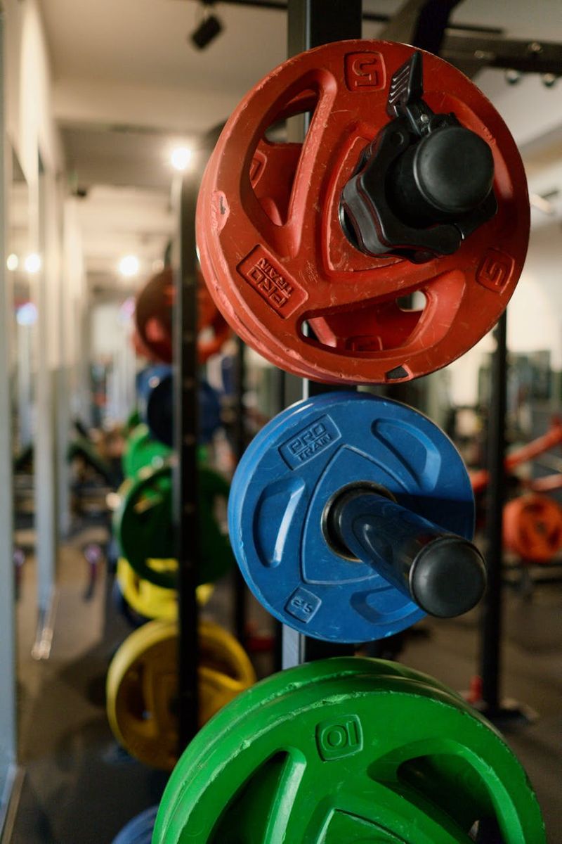 Detailed view of gym weights and athlete hands.