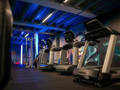 Gym interior with minimalist equipment and neon light.